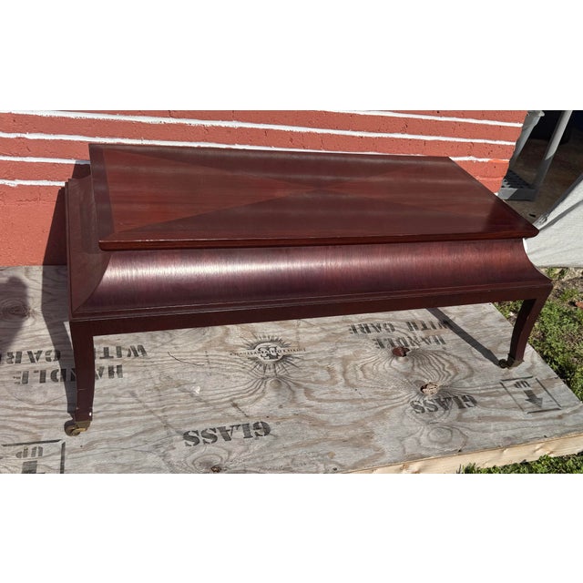 Sophisticated and rare designer cocktail table by Michael Berman, featuring a canterbury-style mahogany frame with slatted...