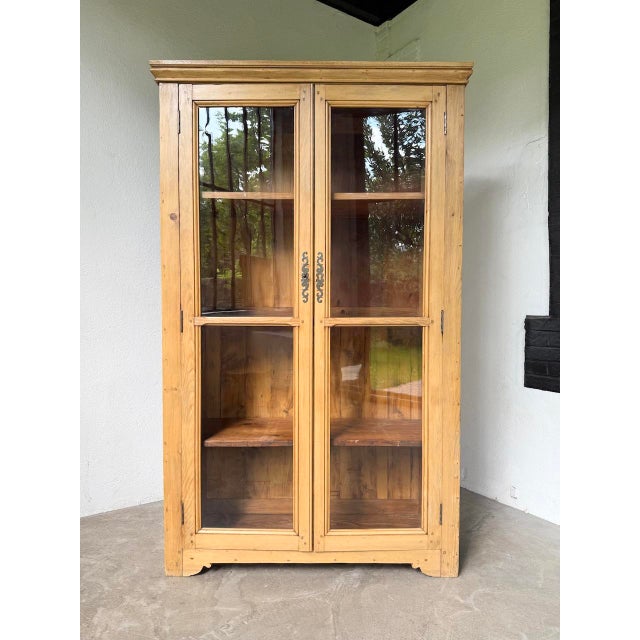 Antique pine glass cabinet or display case from the 1950s. very elegant overall look with its two large glass doors and...