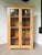 Antique pine glass cabinet or display case from the 1950s. very elegant overall look with its two large glass doors and...