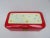 A fancy bread box from the 40s, enamelled in red with a decor on the lid made of light blue stars and circles as well as...