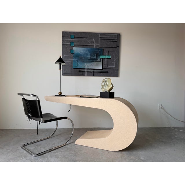 A striking 1980s Postmodern console table featuring a bold geometric waterfall silhouette with sculptural curves and a...
