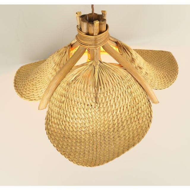 The lamp consists of three woven compartments attached to a bamboo frame. When the lamp is lit, it emits a beautiful, warm...