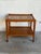 This two-tier mobile cart features an upper shelf with ceramic tiles and a lower wooden tier. Smooth rolling casters...