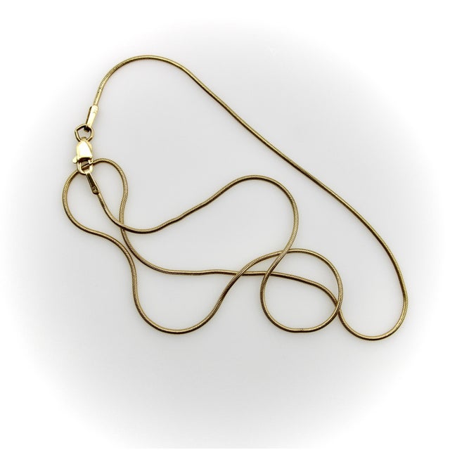 This vintage snake chain is super fluid, allowing charms to move up and down it easily. Sleek and slinky, it also looks...
