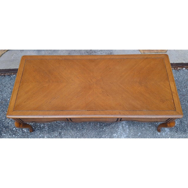 Weiman Mid Century Provincial Style Fruitwood and Bookmatched Top Coffee / Cocktail Table. Measure 46" in width, 21" in...
