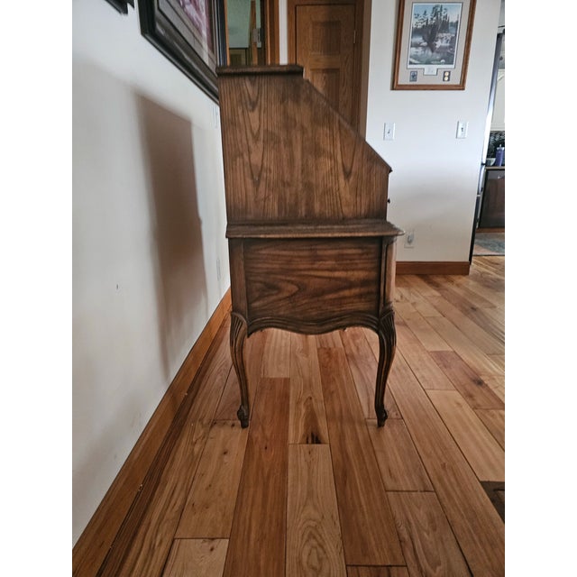 This piece is a beautifully balanced expression of mid-century romance, this vintage slant-front secretary desk from Dixie...