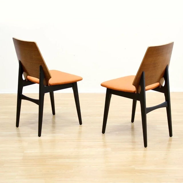This pair of mid-century occasional/dining chairs were made in England during the 1950s. With ebonized frames and curved...