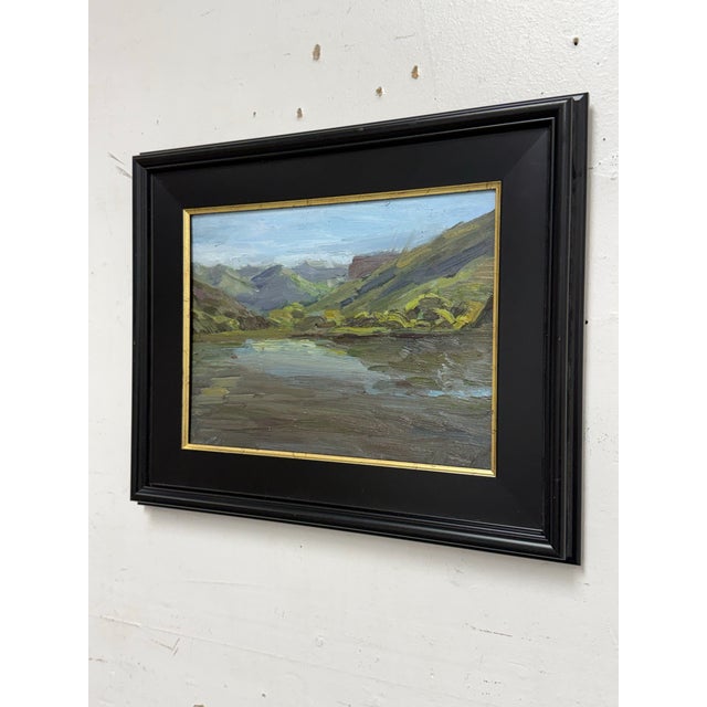 Design Plus Gallery presents a Framed Oil on Canvas Landscape. The composition depicts water reflecting mountains and...