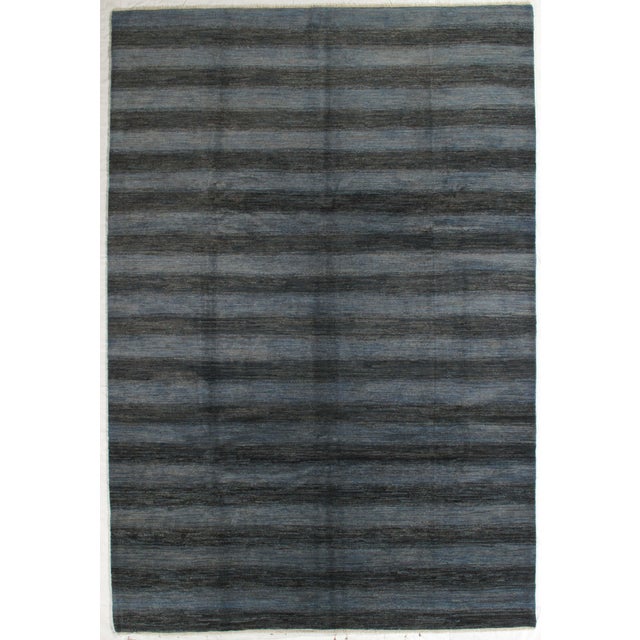 Vintage hand-knotted Gabbeh rug with a subtle striped field and tonal variation. Woven in wool with a minimalist, linear...