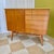 Vintage mid-century modern teak sideboard from Sweden. Features a single-door cupboard with shelves and a bank of five...