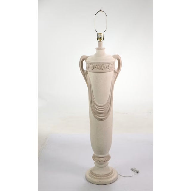 Commanding and sculptural, this monumental molded plaster floor lamp captures the essence of classic Neoclassical grandeur...