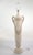 Commanding and sculptural, this monumental molded plaster floor lamp captures the essence of classic Neoclassical grandeur...