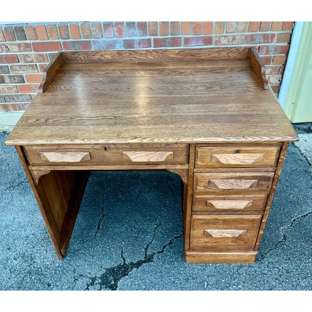 Nice solid oak desk dating to the early 1900s. Features a deep desktop with backsplash, single center drawer and four...