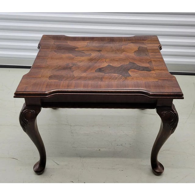 A wonderful Queen Anne style accent table with a mixed wood patchwork veneer table top. It is in excellent condition...