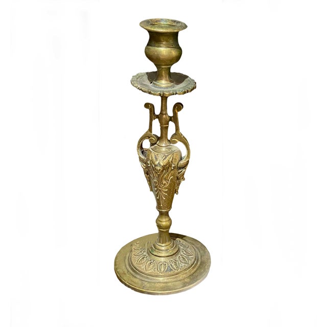 A pair of French bronze candlestick holders depicting urns.