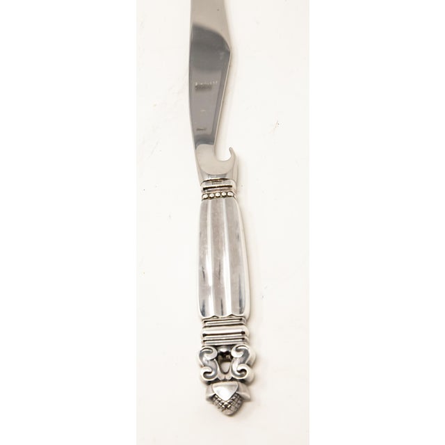 Offering this elegant Georg Jensen pronged bar knife. The pattern of the knife is acorn. The handle is marked Sterling,...