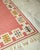 Vintage Swedish Kilim rug by Swedish textile designer Anna Greta Sjöqvist. Beautiful pink/red base with a geometric...