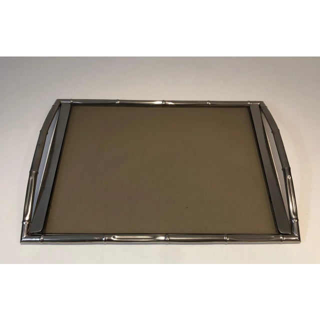 This faux-bamboo tray is made of chrome with smoked glass. This is a French work, in the style of famous French designer...