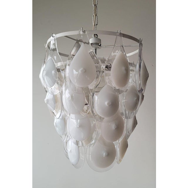 An elegant pendant chandelier made of mouth-blown opaline glass, designed by Gino Vistosi and produced by the historic...