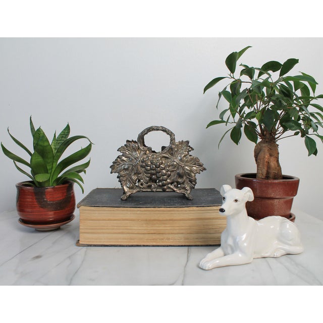 Vintage 1994 Godinger silver plated grapevine napkin holder. Makers mark on bottom. Tarnishing.