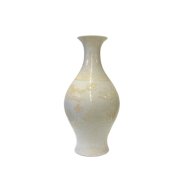 This is a Chinese decorative porcelain vase in off White base color. The theme is oriental flower and bird scenery...
