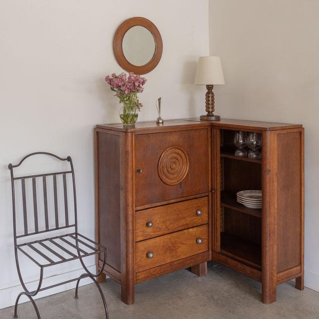 Incredible and rare carved wood corner cabinet by Charles Dudouyt from France, 1940s. Beautiful carved circle detail on...