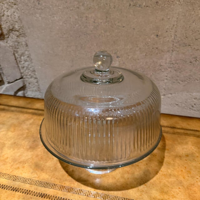 For your consideration, a vintage ribbed glass cake stand with dome cover, often used as a collectible item. Design:...