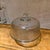 For your consideration, a vintage ribbed glass cake stand with dome cover, often used as a collectible item. Design:...