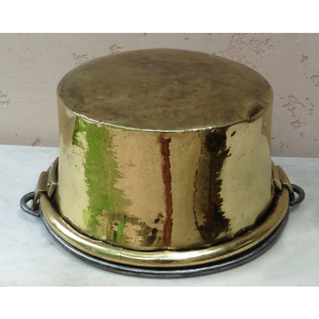 Early 19th French yellow copper cauldron with iron folding handle, polished.