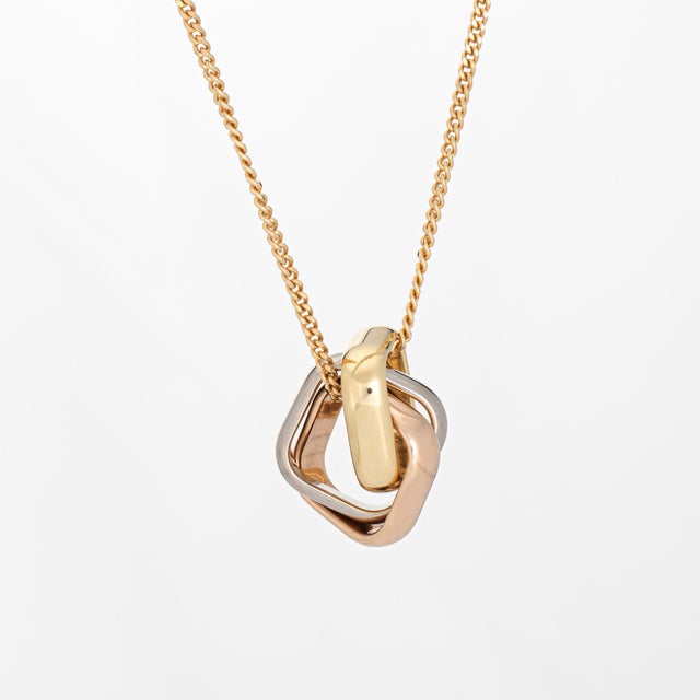Stylish and finely detailed pre-owned Cartier Cushion shaped pendant & necklace crafted in 18k yellow gold (current...
