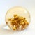 A wonderful vintage acrylic paperweight featuring a dried flower arrangement in the center. Measures 3"Dia x 2.5"H