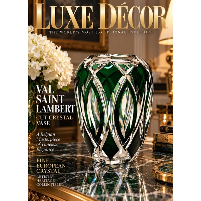 This is a heavy, bulbous crystal vase featuring a vibrant emerald green overlay cut back to clear glass in an intricate...
