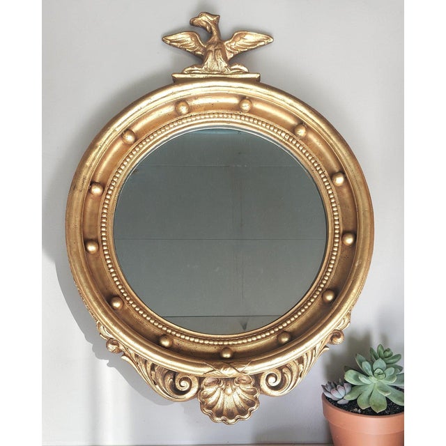 A striking vintage Federal-style eagle mirror featuring a beautifully detailed eagle crest and thirteen decorative balls...