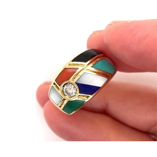 This authentic ring by Asch Grossbardt is crafted in solid 14k yellow gold and showcases the designers signature mosaic...