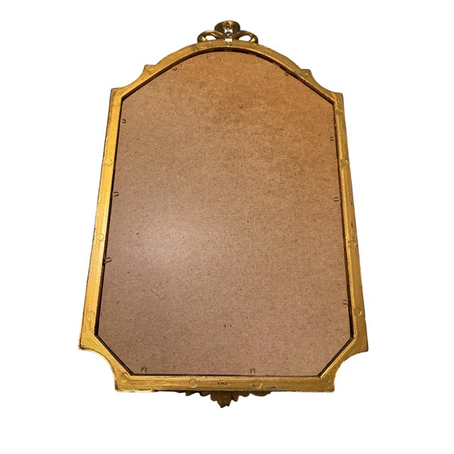 A quality Italian giltwood wall mirror in the Louis XVI Neoclassical manner. The outer frame has a shaped outline...