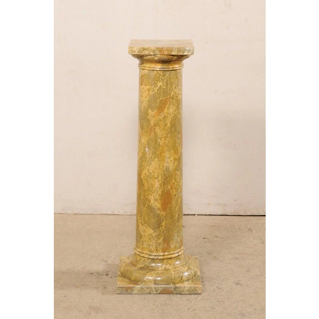 A French faux-marble painted wood column from the mid 20th century. This vintage pedestal from France has a round-shaped...