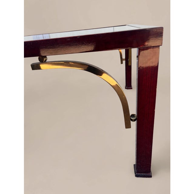Superb coffee table with a high-gloss wood frame and solid brass arches and spheres. The tabletop is made of brand-new 8...