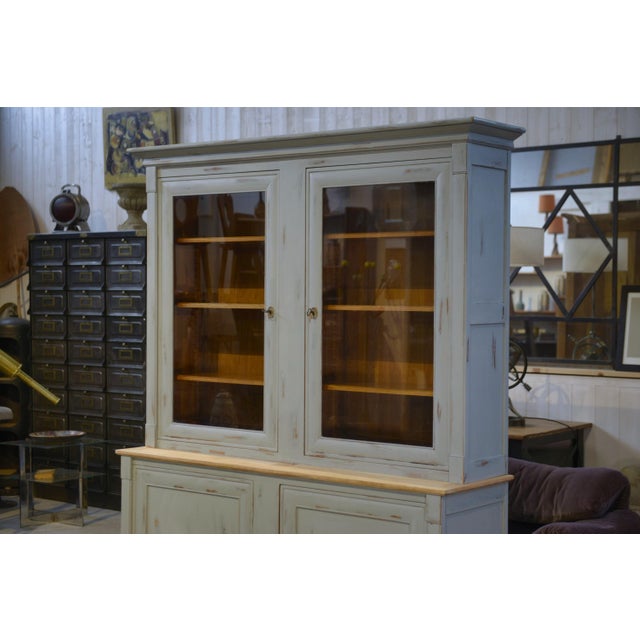 A two-part Crozatier sideboard with a patinated finish, dating from the 1980s, comprising a closed lower section and a...