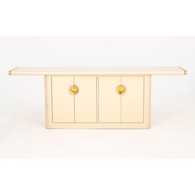 Asian Modern Style Beige Laminate and Gold-Tone Metal Sideboard, with two two-door compartments opening to shelves and...