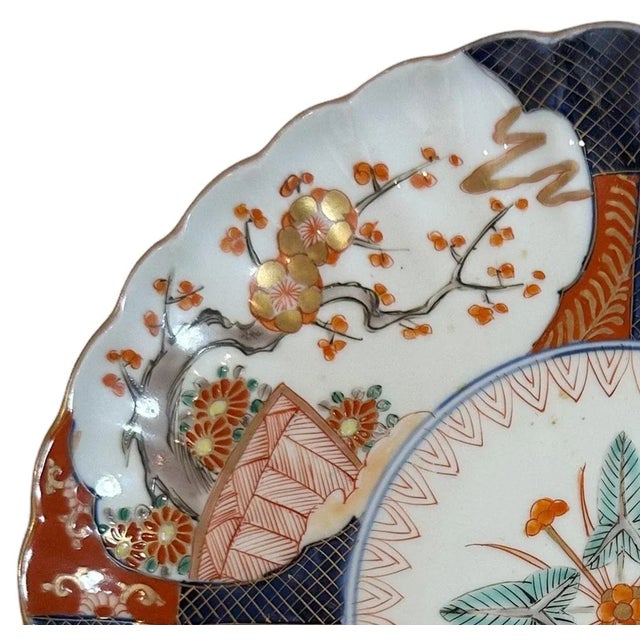 A late 19th century Japanese Imari plate that is very finally painted and with a scalloped edge. Plate is signed in...