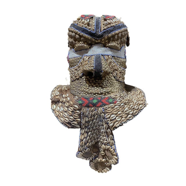 This impressive and unique large vintage beaded Kuba royal head mask from the Congo is crafted from wood, cloth, and...