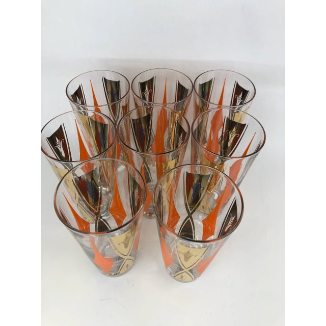 Set of 8 Vintage Mid-Century Cooler Glasses with orange diamonds and gold decoration. Glasses measure 5 5/8" tall x 2 3/4"...