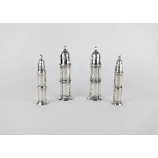 A set of solid silver salt and pepper shakers by Marie Zimmermann, designed in the Neoclassical Revival style with swag...