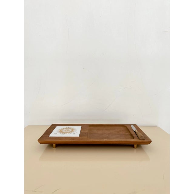 Classic midcentury teak cheese board with butter knife and tile insert on brass legs, made by Georges Briard c.1960s....