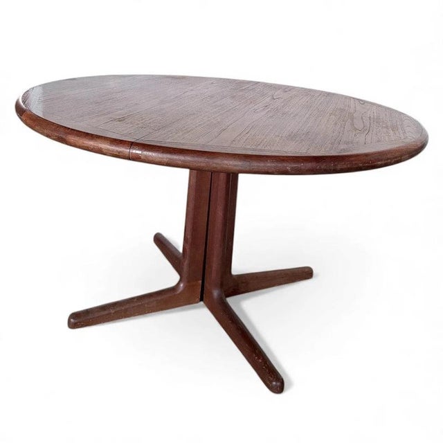 The Danish teak dining table is a beautifully crafted mid-century modern table designed by Laurits M. Larsen that brings...