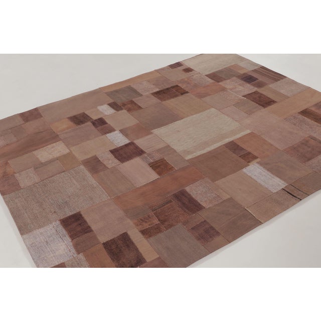 Handwoven in wool and cotton circa 1950–1960, this 6x8 vintage patchwork rug is a refined addition to Rug & Kilim’s...