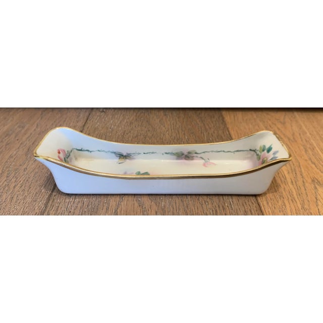 Japanese hand painted pencil holder. The floral motif is painted in soft hues of pink and green.