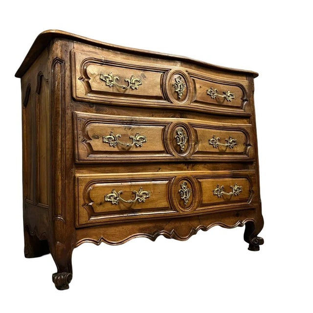 Louis xv period lyonnaise commode in solid walnut, circa 1750. opens at the front with three molded drawers. wooden top....
