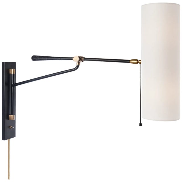 Frankfort Articulating Wall Light in Black and Hand-Rubbed Antique Brass Accents with Linen Shade Designer: AERIN Height:...