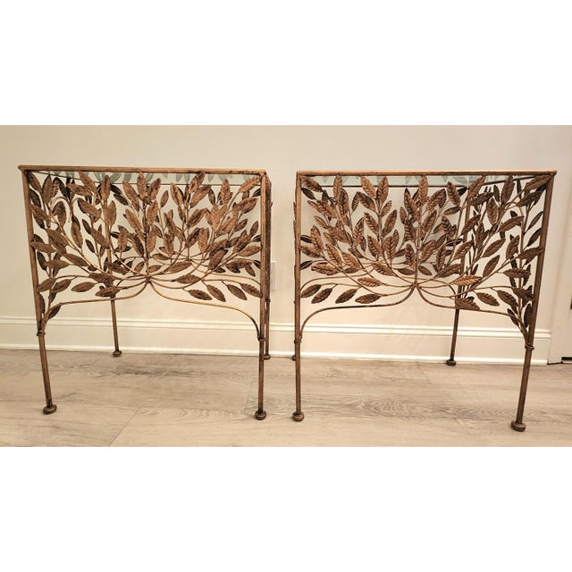 A pair of French Art Deco Revival, Hollywood Regency Style side tables. Features a sculptural botanical design of an...